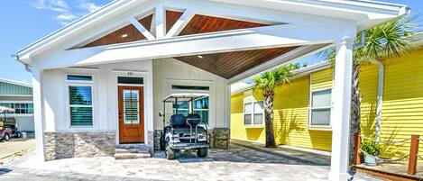 A two-story building with a covered entrance and a golf cart parked outside.