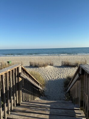 A wooden boardwalk leading to a sandy beach with a clear blue sky. - Best Children & Family Resort- Myrtle Beach, South Carolina-2 Bedroom/2 Bathroom (Myrtle Beach)