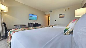 A hotel room with two beds, a desk, a TV, and a small table. - 2 Queen Beds studio with AC in vibrant Honolulu near the Marina & Beach (Honolulu)