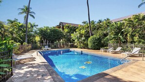 A rectangular swimming pool with a clear blue water surface, surrounded by a concrete deck. There are lounge chairs and a metal fence around the pool. - Kalama Terrace P-307 - 3rd-floor Walkup, 7 min Walk to Charley Young Beach, AC! (Kihei)