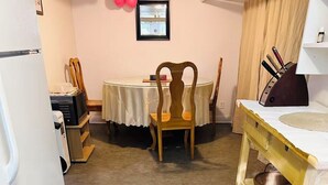 A compact kitchen with a refrigerator, a sink, and a dining table with chairs. - Entire rental unit in Montreal, Canada (Montréal)