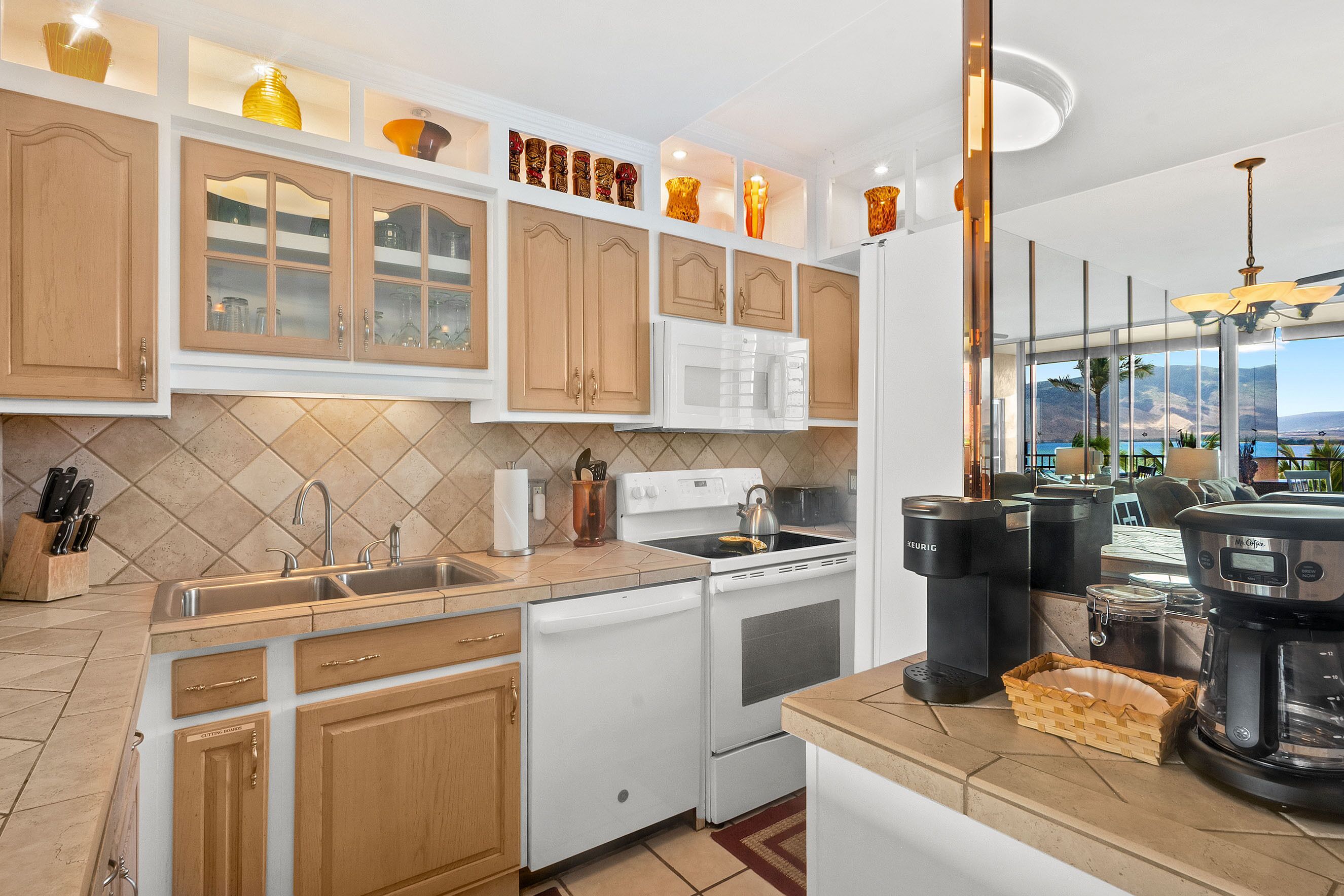 A modern kitchen with wooden cabinets, a white stove, and a coffee maker.