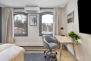 A room with a bed, a desk, a chair, a potted plant, and two windows with curtains. - Sleeps 18+| Hot Tub| Sauna | 7BR Mountain Retreat (Conway)