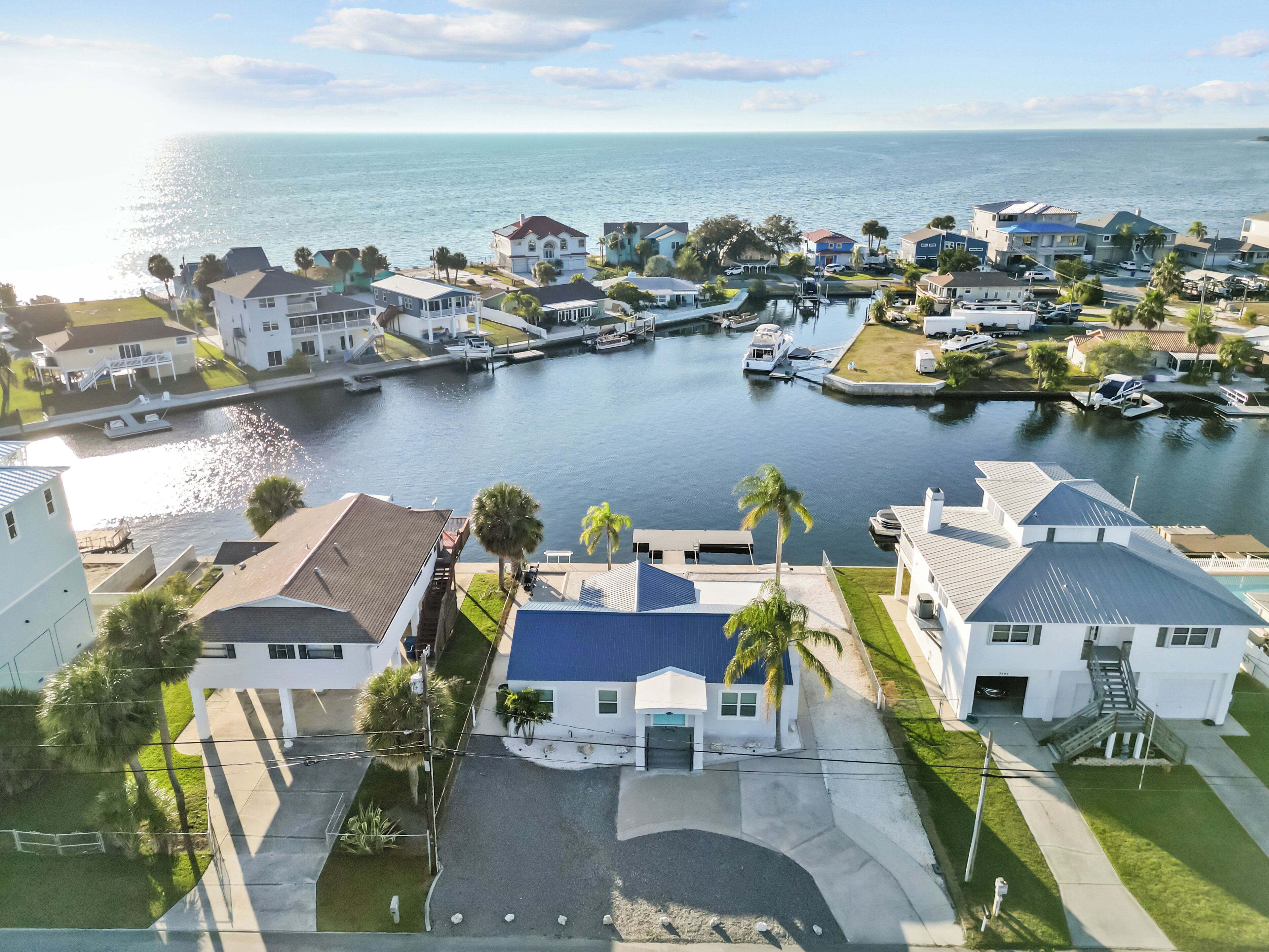 A residential area with houses, a marina, and a body of water.