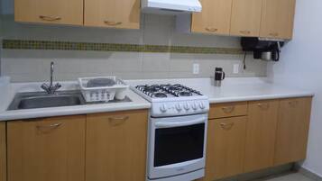 Fridge, microwave, coffee/tea maker, cookware/dishes/utensils