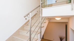 A modern staircase with glass railings and beige steps. - in Stobreč mit privatem Pool by Interhome (Split/Stobreč)