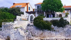 A coastal villa with a stone facade, a pool, and a view of the sea. - mit Blick auf das Wasser by Interhome (Podorljak)