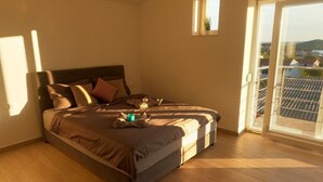 A bedroom with a bed, a small window, and a balcony. - Modernes Ferienhaus mit eigenem Pool und Meerblick by Interhome (Bilice)