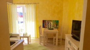 A compact living space with a dining area, a television, and a sofa. - Wohnung in Novigrad mit Möblierter Terrasse by Interhome (Novigrad (Zadar))
