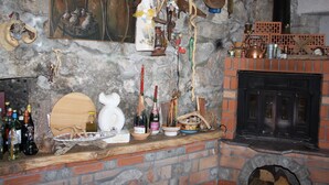 A rustic room with a stone wall, a wooden barrel, and a brick fireplace. - Gemütliche Wohnung Andrea in Opatija by Interhome (Opatija/Pobri)