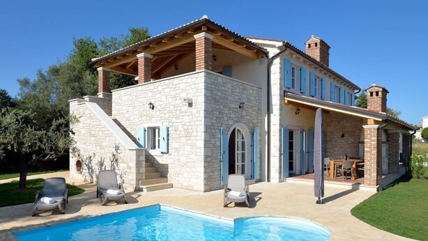 A two-story stone house with a swimming pool, outdoor seating, and a covered patio area. - Villa Miramar by Interhome (Poreč/Tar)