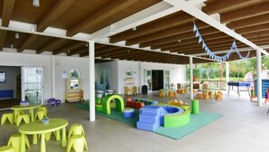 A covered outdoor play area with tables and chairs, play structures, and a slide. - Apartment Noemi3 by Interhome (Poreč/Tar)