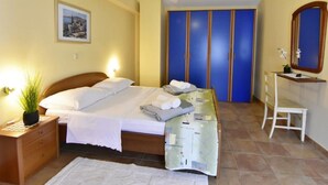 A bedroom with a bed, bedside table, nightstand, and a mirror. - FIORELA 2 by Interhome (Poreč/Tar)