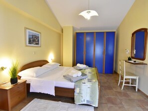 A bedroom with a bed, bedside table, nightstand, and a mirror. - FIORELA 2 by Interhome (Poreč/Tar)
