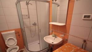 A bathroom with a glass-enclosed shower, a toilet, and a sink with a patterned countertop. - Wohnung "Sonja Dajla" direkt am Strand by Interhome (Buzinija)