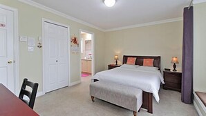 A bedroom with a bed, bedside tables, a chair, and a desk. - aa misu (Richmond)