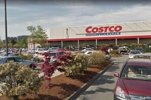 A Costco Wholesale store with a parking lot and surrounding greenery. - Elegant Stay Near YVR (Richmond)