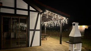 An outdoor patio area with a grill and string lights. - "Dom4" mit Wasserblick by Interhome (Sarbinowo)