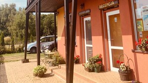 A building with a wooden balcony and a sign reading "RECEPCIA". - Ferienanlage Belona/A1 by Interhome (Niechorze)