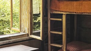A bunk bed with a window, a wooden bench, and a view of greenery outside. - unter der Linde by Interhome (Krzyszkowice)
