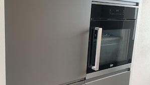A modern kitchen with a built-in oven and microwave. - in Dirkshorn by Interhome (Dirkshorn)