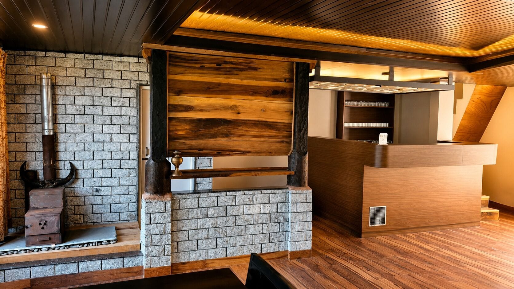 A modern interior with a brick wall, wooden accents, and a built-in wooden shelf.