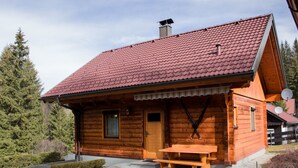 A wooden cabin with a red-tiled roof, a wooden porch, and a picnic table. - Holzhaus Klippitzblickhütte by Interhome (Bad St. Leonhard im Lavanttal)