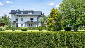 A two-story residential building with solar panels, a balcony, and a well-maintained garden. - Appartement in Unterburg Am Klopeiner See by Interhome (Klopeiner See)