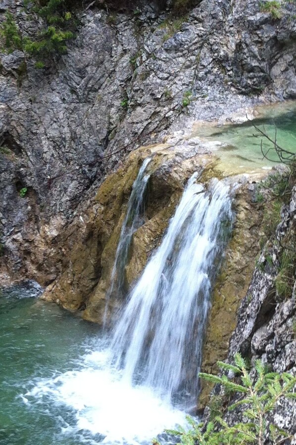 A waterfall cascading over a rocky cliff into a pool.