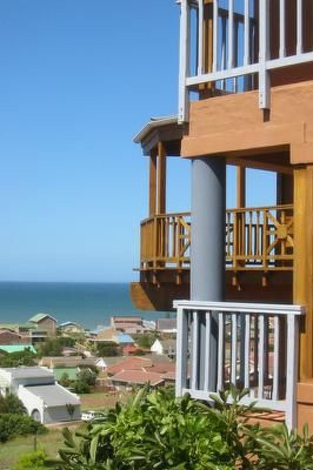 A multi-story building with balconies overlooking a coastal area.