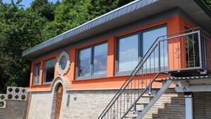 A modern building with a brick facade, large windows, and a metal staircase. - Bungalow "Schönblick" am Elberadweg in Pirna by Interhome (Pirna)