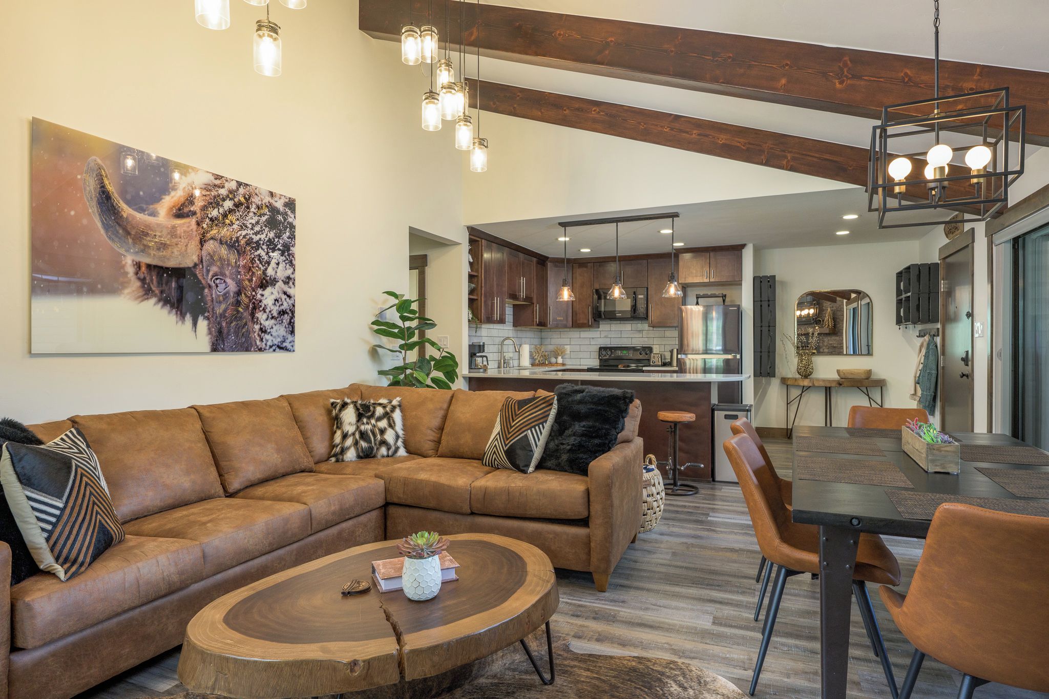 Living Room has an open floor plan w/ vaulted ceilings, fireplace & 50" Smart TV