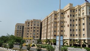 A multi-story hotel with a symmetrical facade, multiple balconies, and a central entrance. - Jagannath Puri Beach Stay (Brahmagiri)