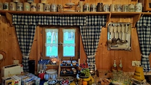 A wooden cabin interior with a breakfast setup including cereal, fruits, and beverages. - FeWo Steinbeisser by Interhome (Arrach)