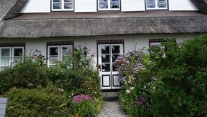 A traditional thatched-roof house with white walls and multiple windows. - Geltinger Birk by Interhome (Gelting)