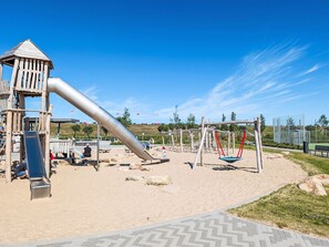 A playground with a slide, swings, and climbing structures. - Diekbude by Interhome (Friedrichskoog)