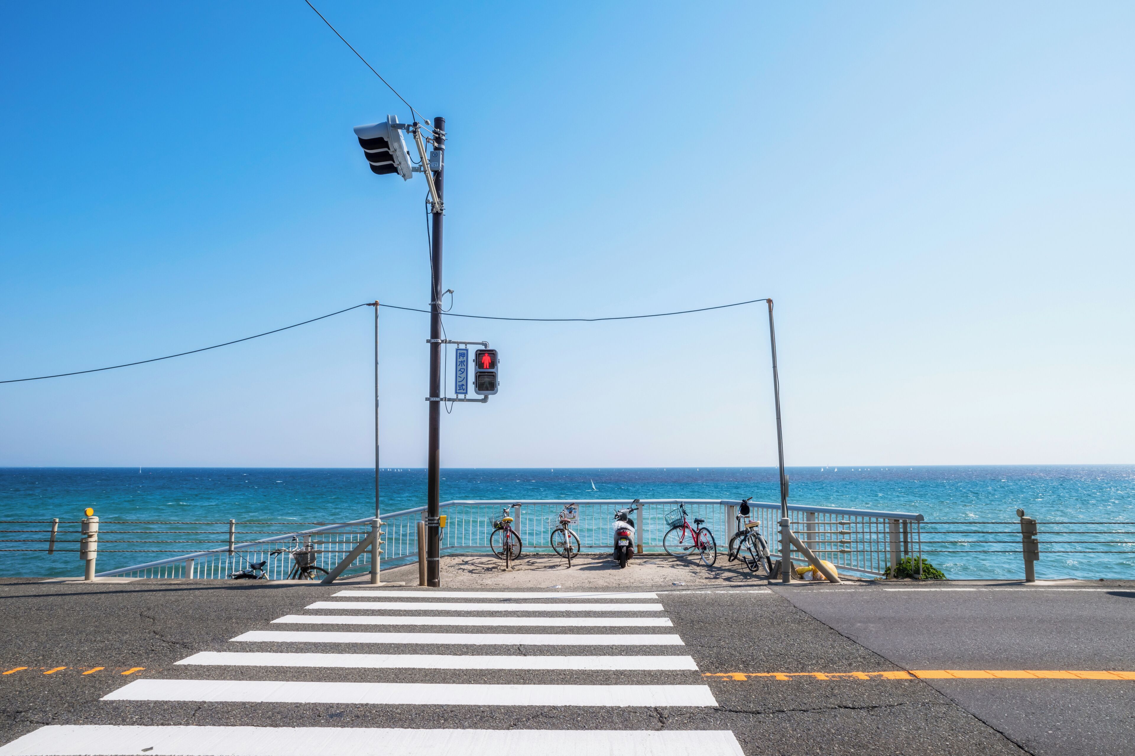 A pedestrian crossing with a view of the sea.