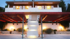 A two-story building with a covered entrance and a staircase leading to the upper floor. - Strandnahe Ferienwohnung in Podstrana by Interhome (Podstrana)