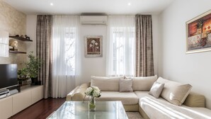 A modern living room with a glass coffee table, beige sofa, and a flat-screen TV. - Villa Meri Split by Interhome (Dragovode)