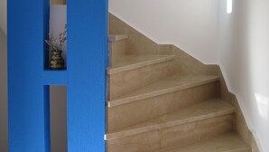 Eine Treppe mit beigen Stufen und einer blauen Wand.