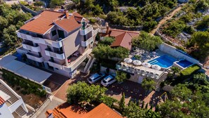 A multi-story building with a swimming pool and outdoor seating area. - Strandnahes Ferienhaus mit Garten in Ražanj by Interhome (Rogoznica/Ražanj)