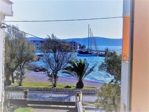 A balcony with a view of a marina, boats, and distant hills. - Apartment im ersten Stock für bis zu 5 Personen by Interhome (Zadar/Bibinje)