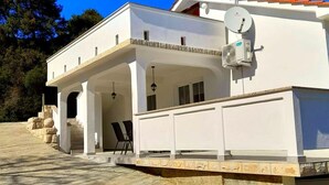 A white building with a covered patio and a satellite dish. - in Kampor mit Privatparkplatz by Interhome (Rab/Kampor)