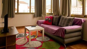 A cozy room with a sofa, a small table, and a colorful rug. - Appartement in Palit mit Privatem Balkon by Interhome (Rab/Rab)