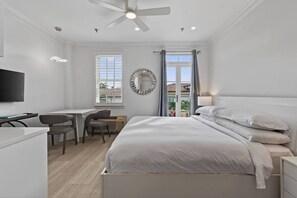 A modern bedroom with a bed, a desk, and a television. - Special/Pool/StepsToBeach/Terrace Studio (Palm Beach)