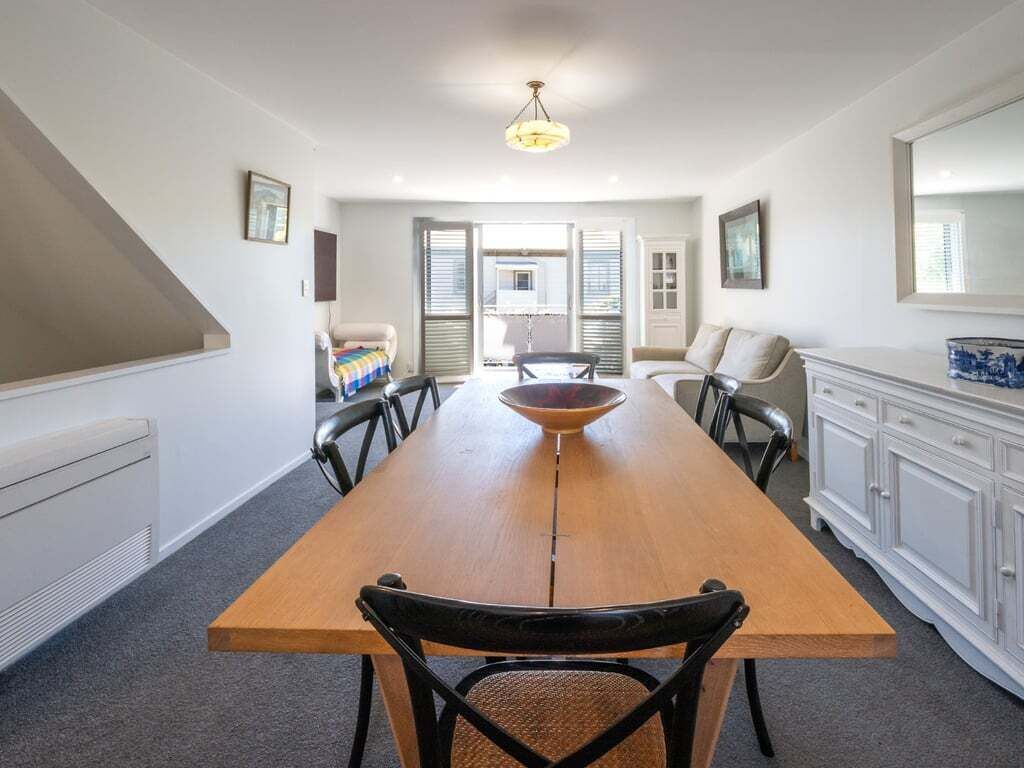 A bright, open-plan living space with gentle French charm, opening to the balcony for dreamy Akaroa moments.