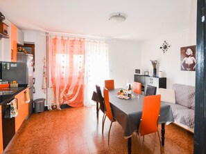 A compact kitchen with a dining area, a sofa, and a TV. - Wohnung "Gabi" mit Terrasse by Interhome (Novigrad (Istra))