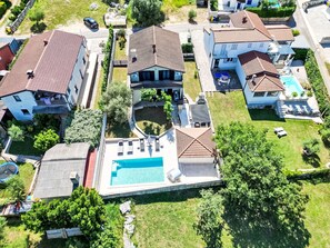 A residential area with houses, a swimming pool, and a small garden. - Haus Marija**** by Interhome (Umag/Juricani)