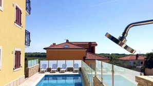 A rooftop pool with a clear view of the surrounding area, including a yellow building with red shutters and a red-tiled roof. - Apartment Elia 1 by Interhome (Umag/Savudrija)
