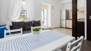A modern kitchen with a built-in refrigerator and wooden cabinets. - "Apartment1" mit Gemeinschaftspool by Interhome (Rewal)